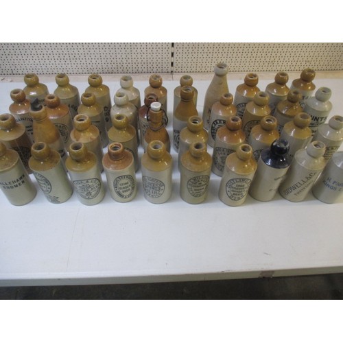 287 - 40 vintage stoneware ginger beer bottles, all with manufacturers names from Norfolk, some damages bu... 