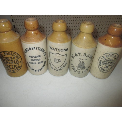 287 - 40 vintage stoneware ginger beer bottles, all with manufacturers names from Norfolk, some damages bu... 