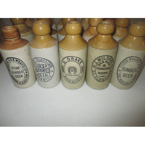 287 - 40 vintage stoneware ginger beer bottles, all with manufacturers names from Norfolk, some damages bu... 