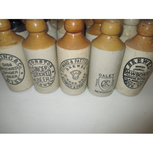 287 - 40 vintage stoneware ginger beer bottles, all with manufacturers names from Norfolk, some damages bu... 