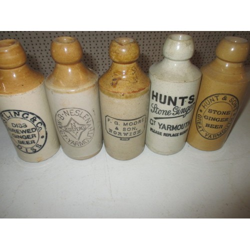 287 - 40 vintage stoneware ginger beer bottles, all with manufacturers names from Norfolk, some damages bu... 