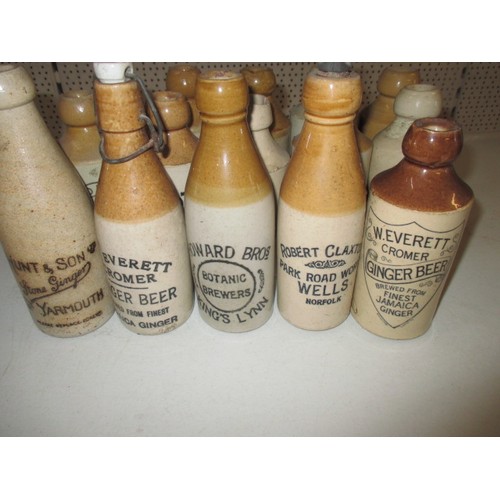 287 - 40 vintage stoneware ginger beer bottles, all with manufacturers names from Norfolk, some damages bu... 