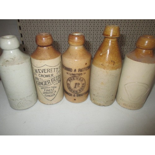 299 - 40 vintage stoneware ginger beer bottles, most with manufacturers names from Norfolk, some age relat... 