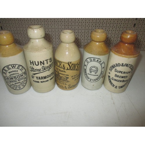 299 - 40 vintage stoneware ginger beer bottles, most with manufacturers names from Norfolk, some age relat... 