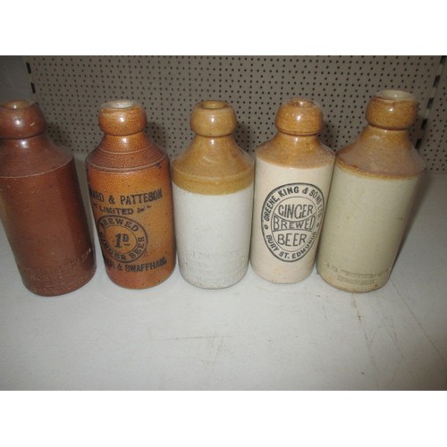 299 - 40 vintage stoneware ginger beer bottles, most with manufacturers names from Norfolk, some age relat... 