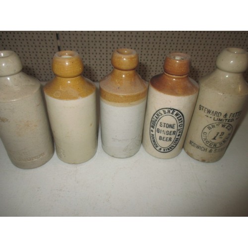 299 - 40 vintage stoneware ginger beer bottles, most with manufacturers names from Norfolk, some age relat... 