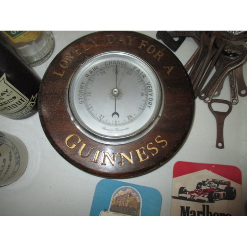 321 - An assortment of drinks related items, to include a Guinness barometer, Babycham mirror and vintage ... 