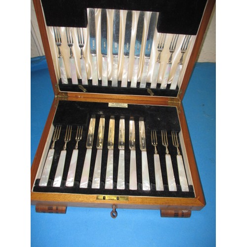 119 - A cased set of sterling silver desert cutlery, 12 place setting with mother of pearl handles, in nea... 