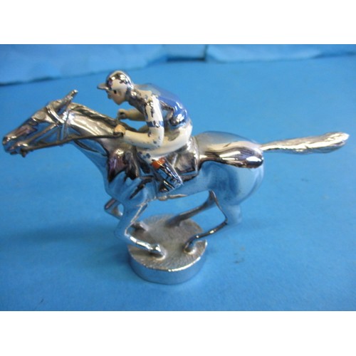 166 - A vintage chrome car mascot, in the form of a horse with jockey, chrome in good condition some ename... 