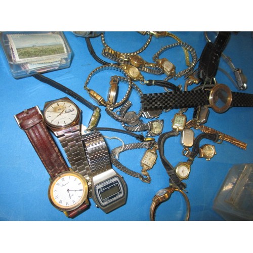 317 - A watch repairers cabinet with contents of parts and watches, all in used condition