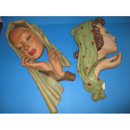 231 - Two large 1930s art deco wall masks, both by Ian Douglas, one has chip to finger the other a chip to... 