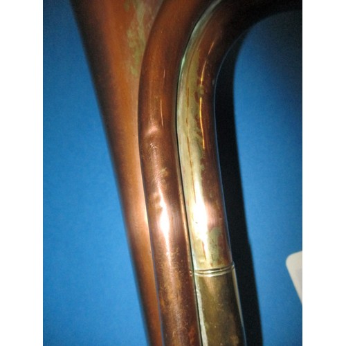 224 - A copper and brass bugle. With age related wear and some minor denting