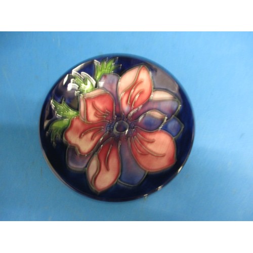 180 - A Moorcroft pin dish in Anemone pattern. Approximate diameter 10.5cm . In good condition with no vis... 