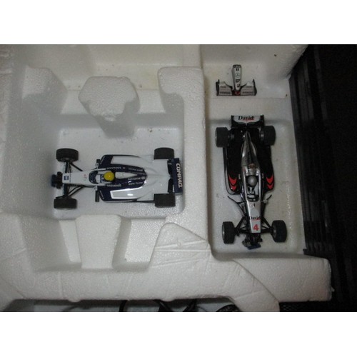 170 - A 1990s Scalextric F1 racing car set, in original box, cars having nose cones missing but in working... 