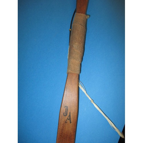 171 - A yew wood archery bow, with various arrows, in good used condition