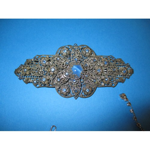 117 - A parcel of costume jewellery, to include a large brooch, in used condition with some missing stones