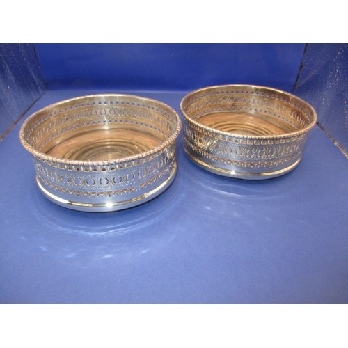 233 - A pair of silver plated bottle coasters, in used condition with some loss of plating and use-related... 