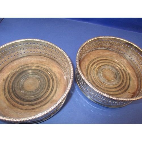 233 - A pair of silver plated bottle coasters, in used condition with some loss of plating and use-related... 