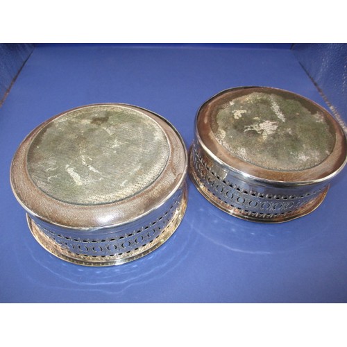 233 - A pair of silver plated bottle coasters, in used condition with some loss of plating and use-related... 