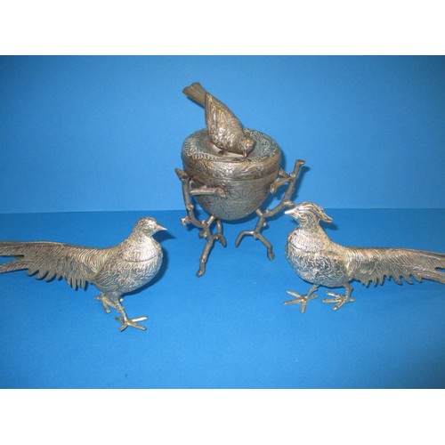 128 - Table decorations consisting of 2 white metal pheasants and a covered pot with a nesting bird