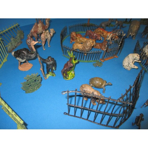 163 - A parcel of 1930s die-cast zoo figures, to include various animals and fencing, some by Britain’s, m... 