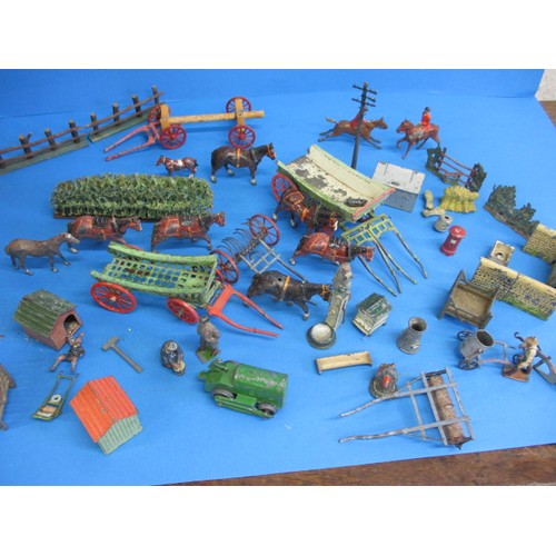 164 - A large quantity of early 20th century die-cast farm items, to include animals and carts, some by Br... 