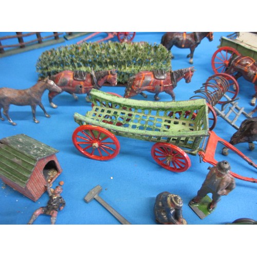 164 - A large quantity of early 20th century die-cast farm items, to include animals and carts, some by Br... 