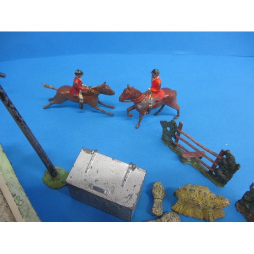 164 - A large quantity of early 20th century die-cast farm items, to include animals and carts, some by Br... 