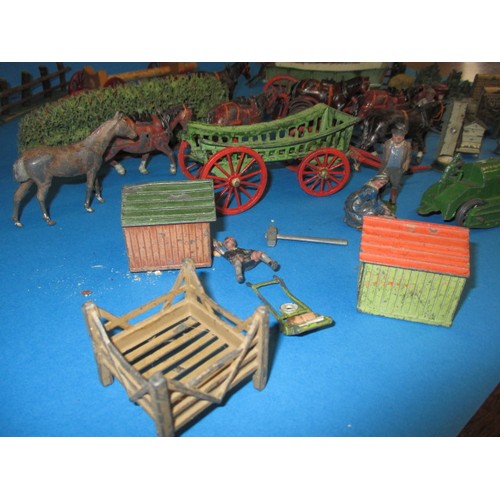 164 - A large quantity of early 20th century die-cast farm items, to include animals and carts, some by Br... 