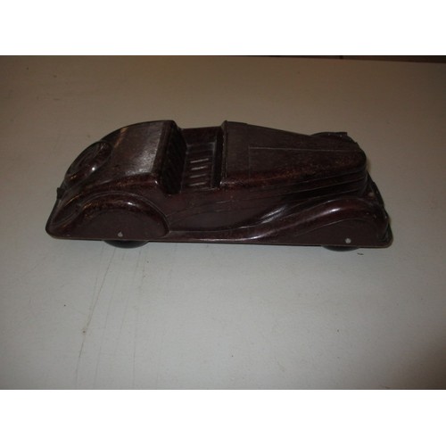 138 - An art deco Codeg Bakelite model car, approx. length 34.5cm, in play worn condition with missing win... 