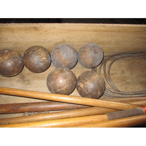 160 - A vintage croquet set in original wood box, having been well used