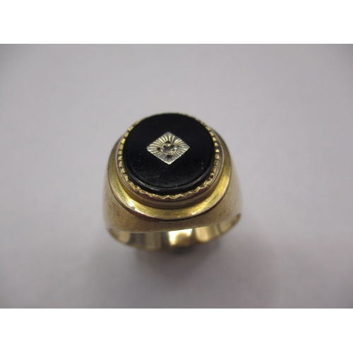 38 - A 9ct gold signet ring with central diamond on jet panel, approx. ring size ‘R’ approx. weight 7g in... 