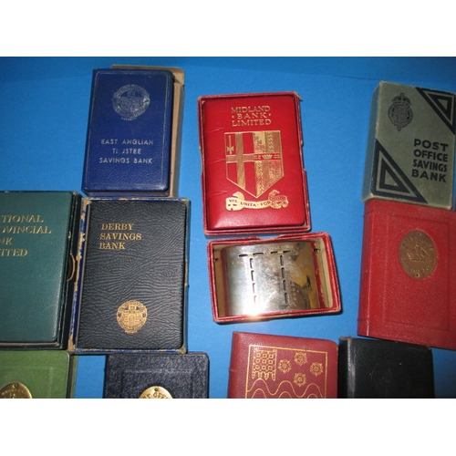 174 - A parcel of vintage post office and bank saving boxes, some with outer card packaging, all in used c... 