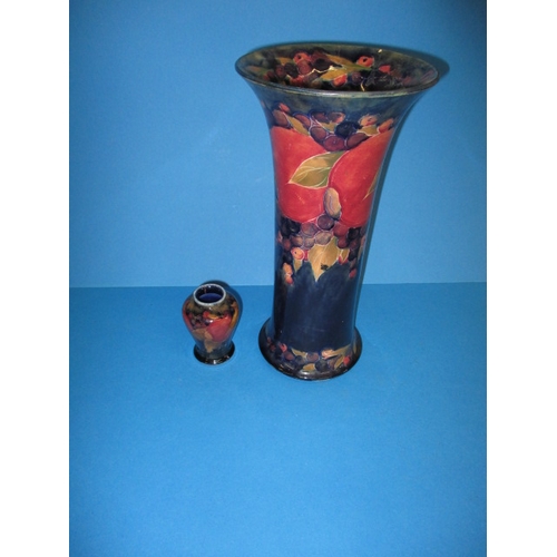 141 - A large 1930s William Moorcroft pomegranate design trumpet vase and a smaller example, display well ... 