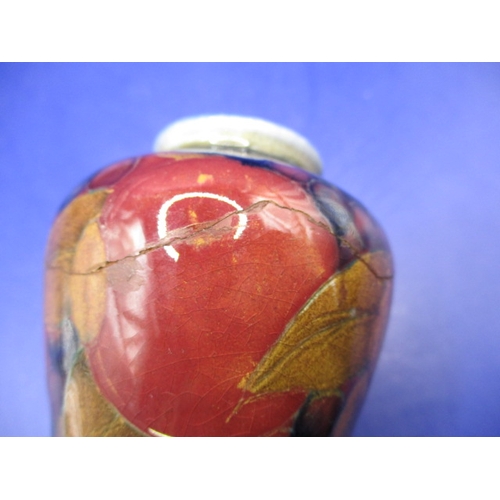 141 - A large 1930s William Moorcroft pomegranate design trumpet vase and a smaller example, display well ... 