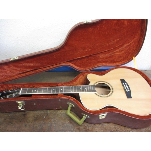 152 - A Hartwood electro acoustic guitar in hard travel case, in very good used condition