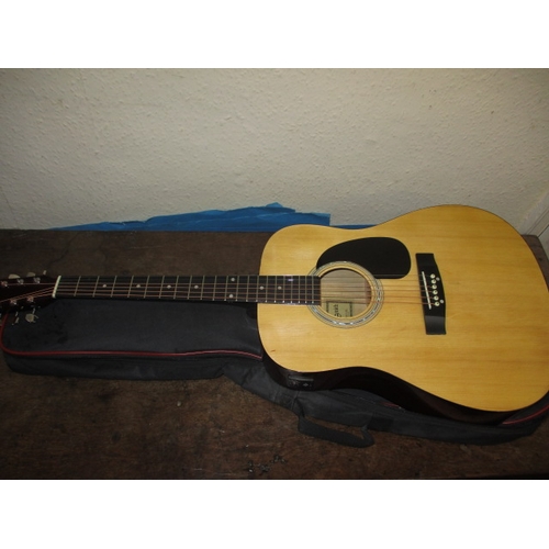 153 - A Martin Smith acoustic guitar with built in tuner and gig bag, in very good used condition