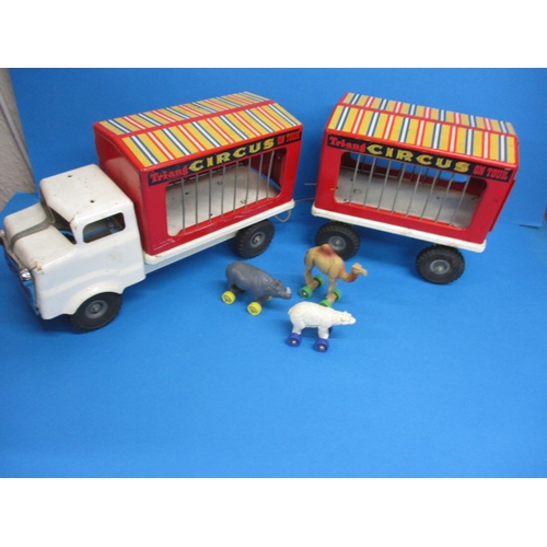 263 - A vintage Tri-ang circus truck and trailer, having some animals, in play worn condition with missing... 