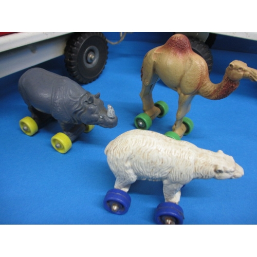 263 - A vintage Tri-ang circus truck and trailer, having some animals, in play worn condition with missing... 