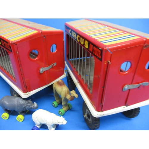 263 - A vintage Tri-ang circus truck and trailer, having some animals, in play worn condition with missing... 