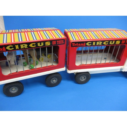 263 - A vintage Tri-ang circus truck and trailer, having some animals, in play worn condition with missing... 