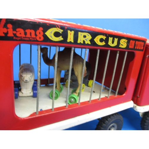 263 - A vintage Tri-ang circus truck and trailer, having some animals, in play worn condition with missing... 