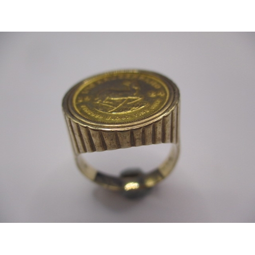 42 - A 9ct gold ring with 1/10 Krugerrand coin dated 1984, approx. ring size ‘R+’ approx. gross weight 8.... 