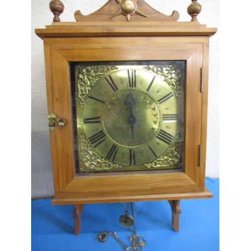 An antique brass bracket clock striking on a bell with 10 inch dial, the wood case of a later date, in need of restoration