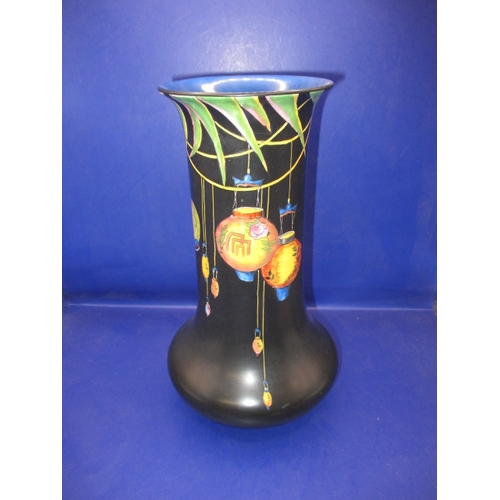 269 - A 1930s Crown Ducal vase, having hand painted Chinese lanterns over a black ground, in good used con... 