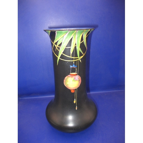 269 - A 1930s Crown Ducal vase, having hand painted Chinese lanterns over a black ground, in good used con... 