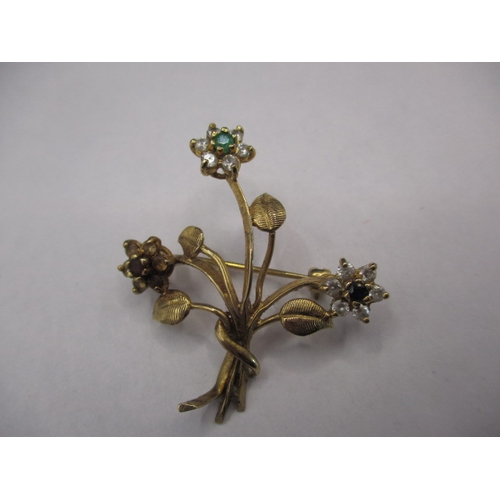 65 - A vintage 9ct gold brooch, being a floral spray set with various stones, approx. weight 4.5g in good... 