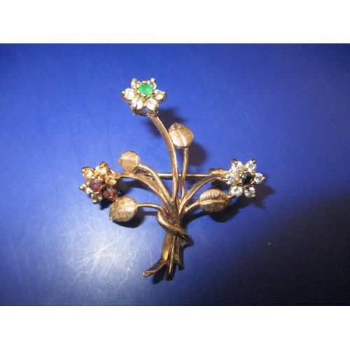 65 - A vintage 9ct gold brooch, being a floral spray set with various stones, approx. weight 4.5g in good... 