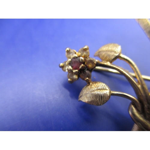 65 - A vintage 9ct gold brooch, being a floral spray set with various stones, approx. weight 4.5g in good... 