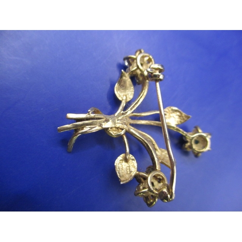 65 - A vintage 9ct gold brooch, being a floral spray set with various stones, approx. weight 4.5g in good... 